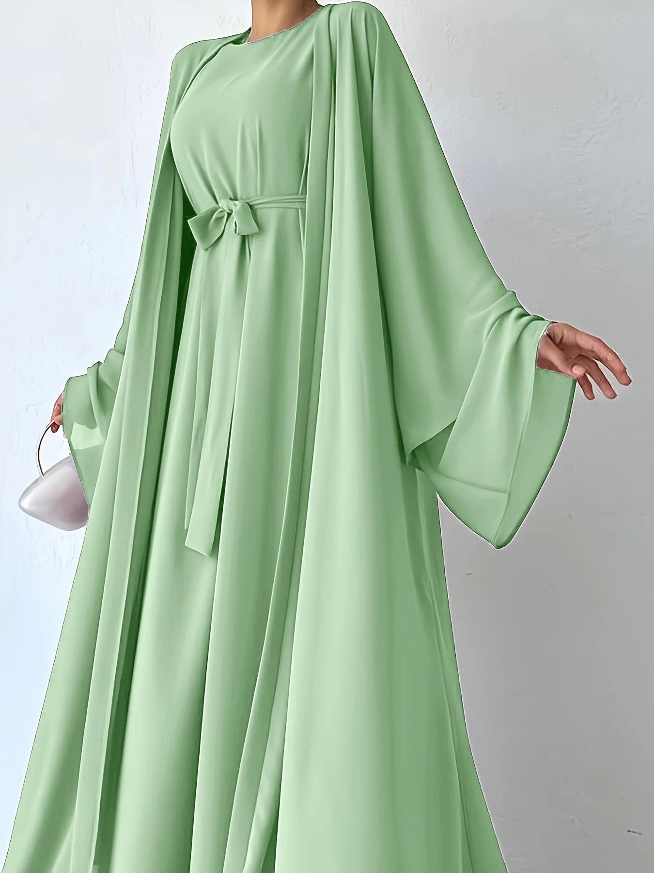 Muslim robe, a two-piece outfit consisting of a vest and a wrap dress, includes a belt.