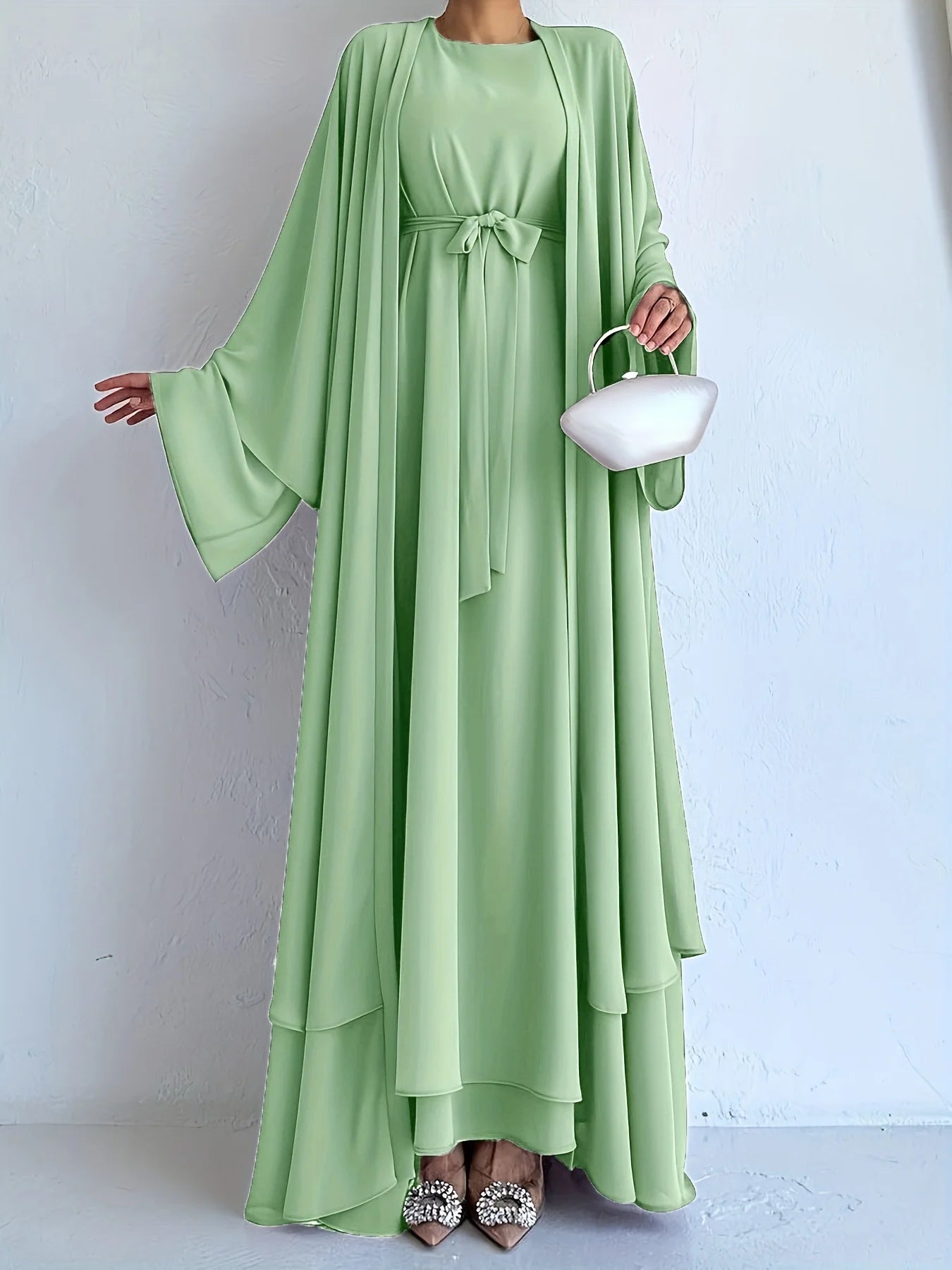 Muslim robe, a two-piece outfit consisting of a vest and a wrap dress, includes a belt.