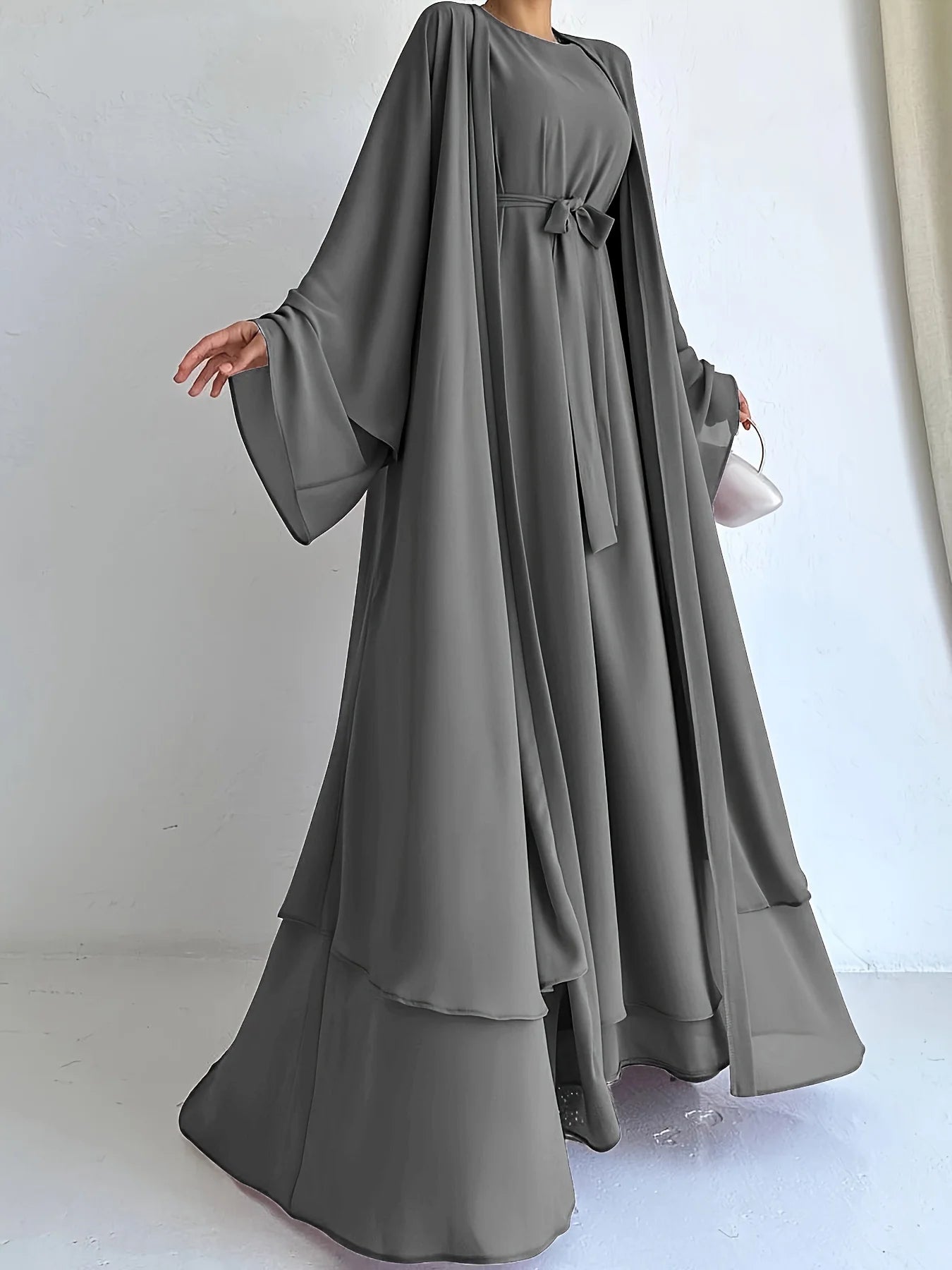 Muslim robe, a two-piece outfit consisting of a vest and a wrap dress, includes a belt.