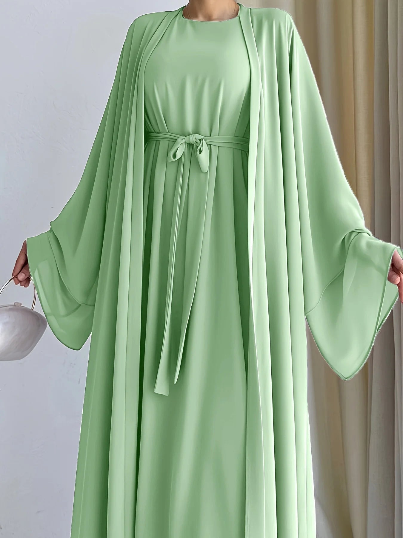 Muslim robe, a two-piece outfit consisting of a vest and a wrap dress, includes a belt.
