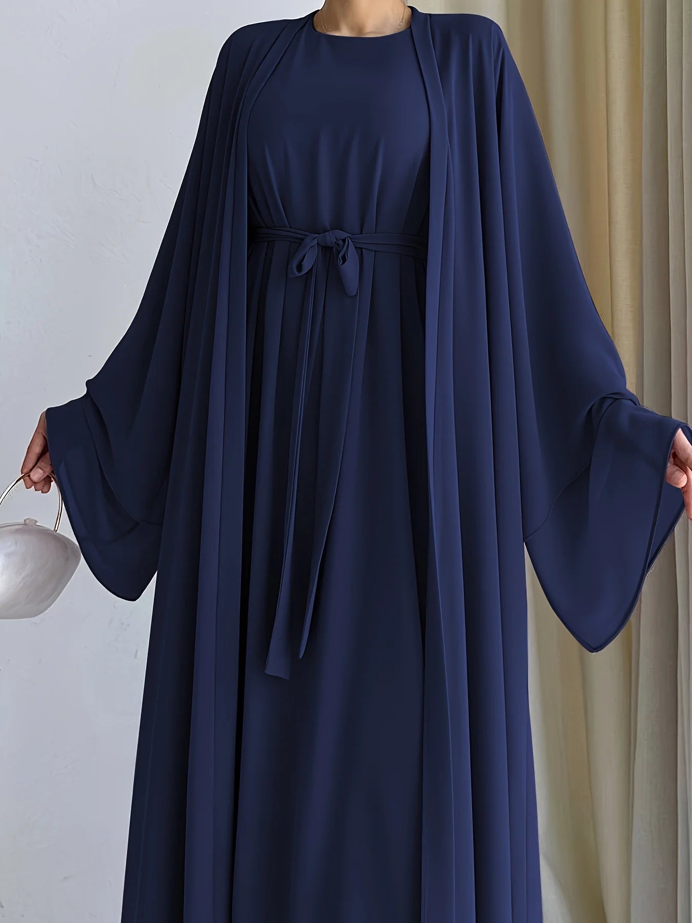 Muslim robe, a two-piece outfit consisting of a vest and a wrap dress, includes a belt.
