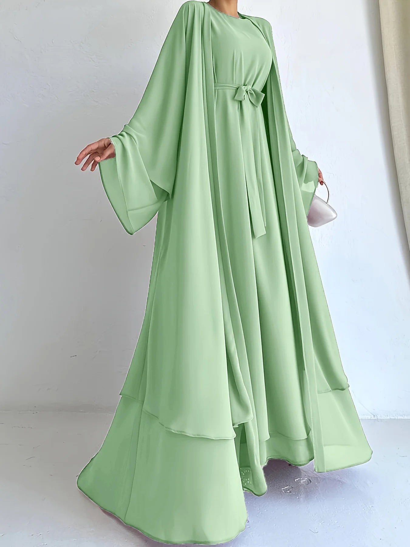 Muslim robe, a two-piece outfit consisting of a vest and a wrap dress, includes a belt.