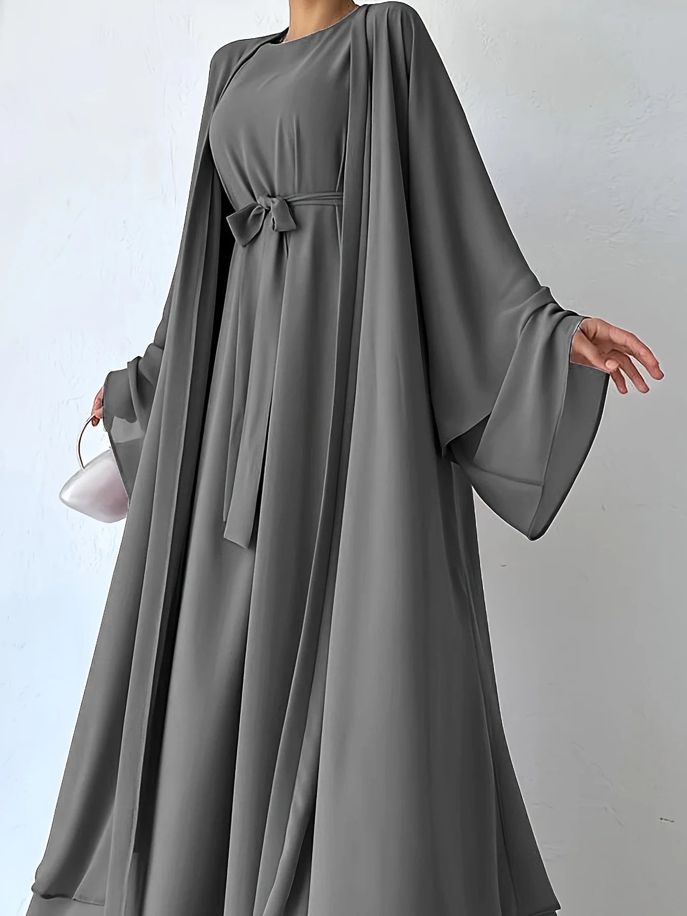 Muslim robe, a two-piece outfit consisting of a vest and a wrap dress, includes a belt.